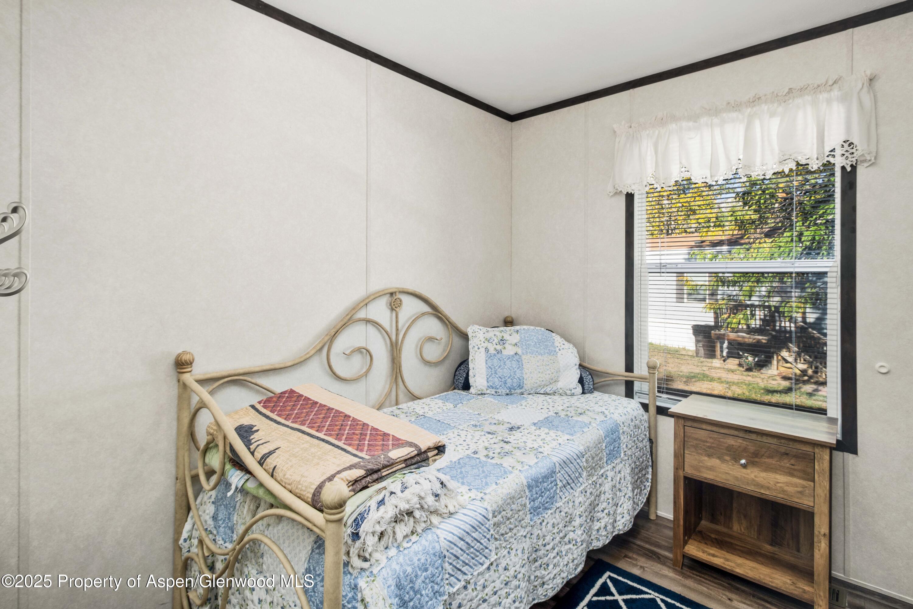 116 Iron Wedge Circle Parachute, CO 81635 - Photo 12 of 20 a bedroom with a bed and a window