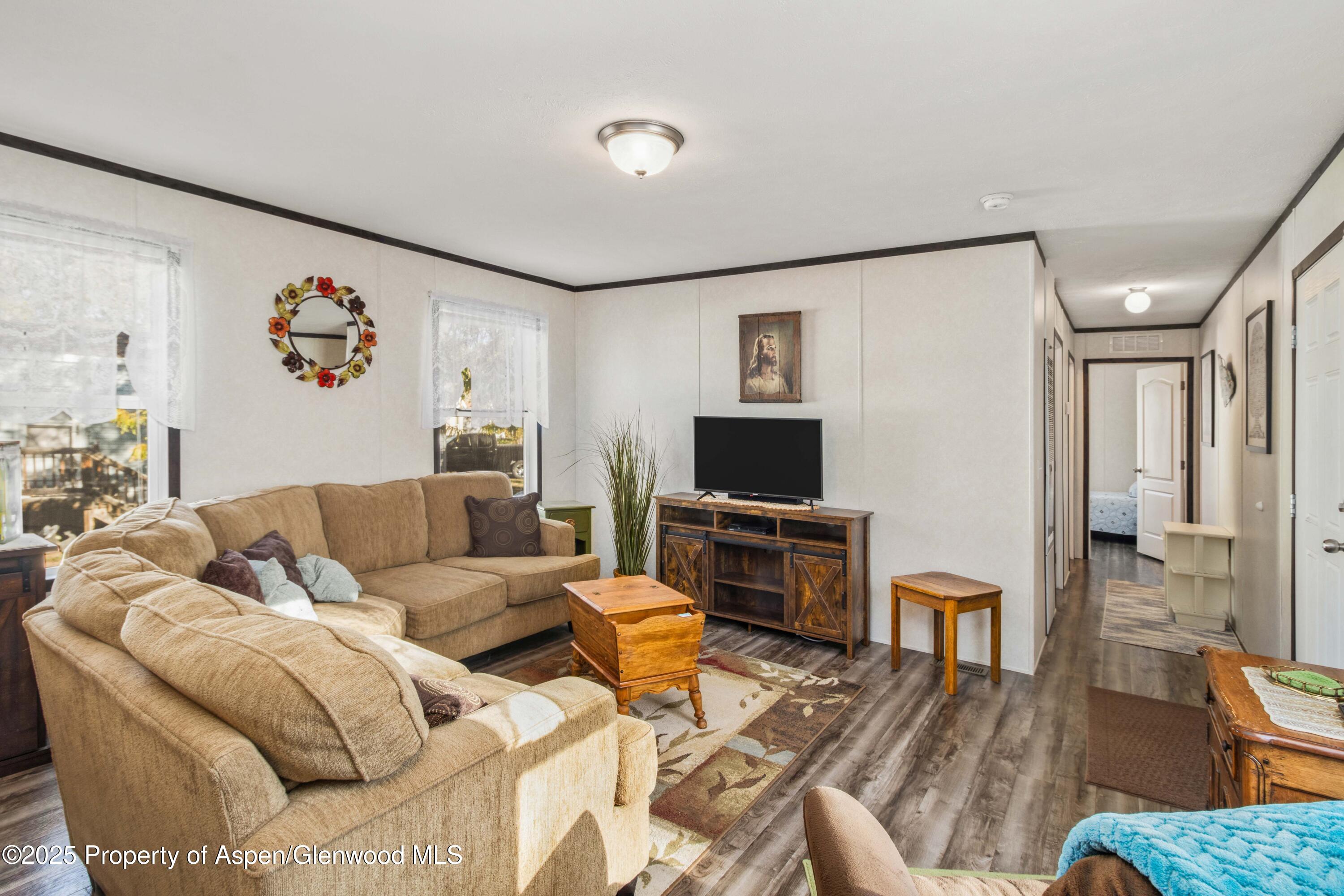 116 Iron Wedge Circle Parachute, CO 81635 - Photo 7 of 20 a living room with furniture and a flat screen tv
