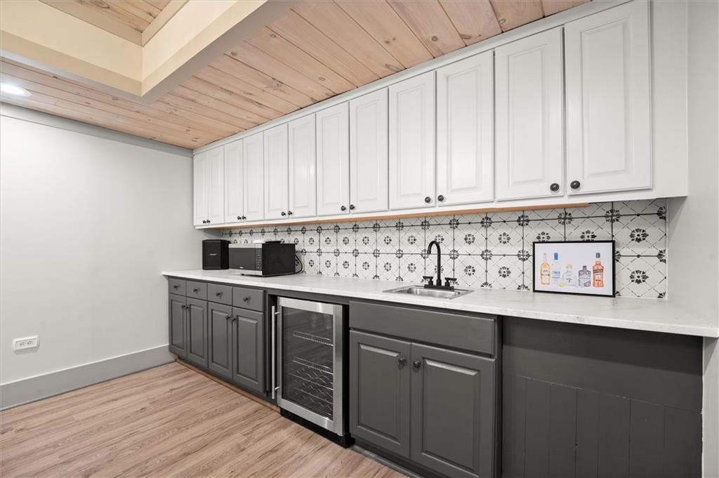 6229 Grand Loop Road Sugar Hill, GA 30518 - Photo 63 of 93 a kitchen with stainless steel appliances granite countertop a sink dishwasher a stove and white cabinets with wooden floor