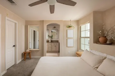 a bedroom with a bed and glass windows