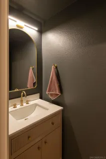 a bathroom with a sink and mirror