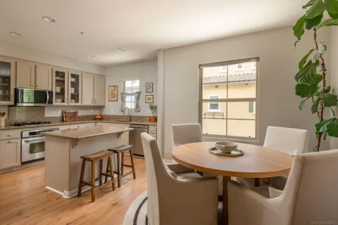a kitchen with a table chairs sink and cabinets