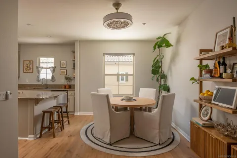 a dining room with furniture wooden floor and a rug