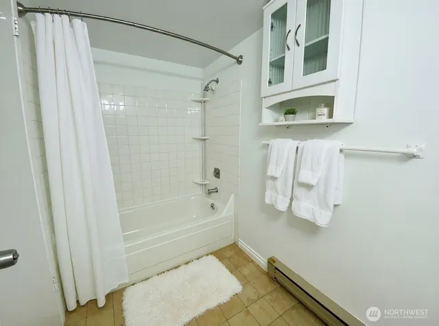 a bathroom with a tub and shower