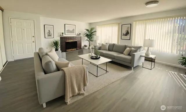 a living room with furniture and a fireplace
