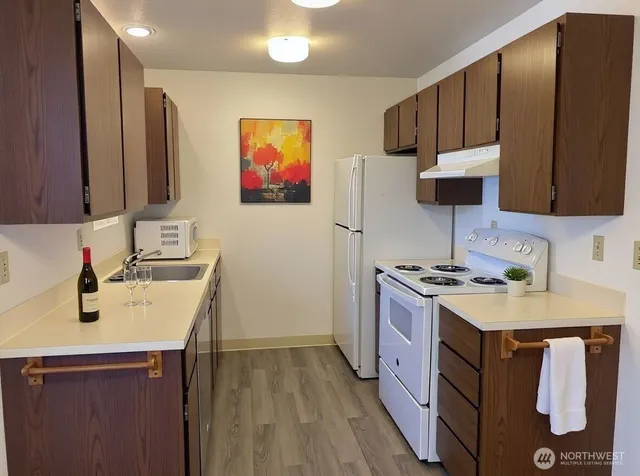 a kitchen with a sink stove and refrigerator