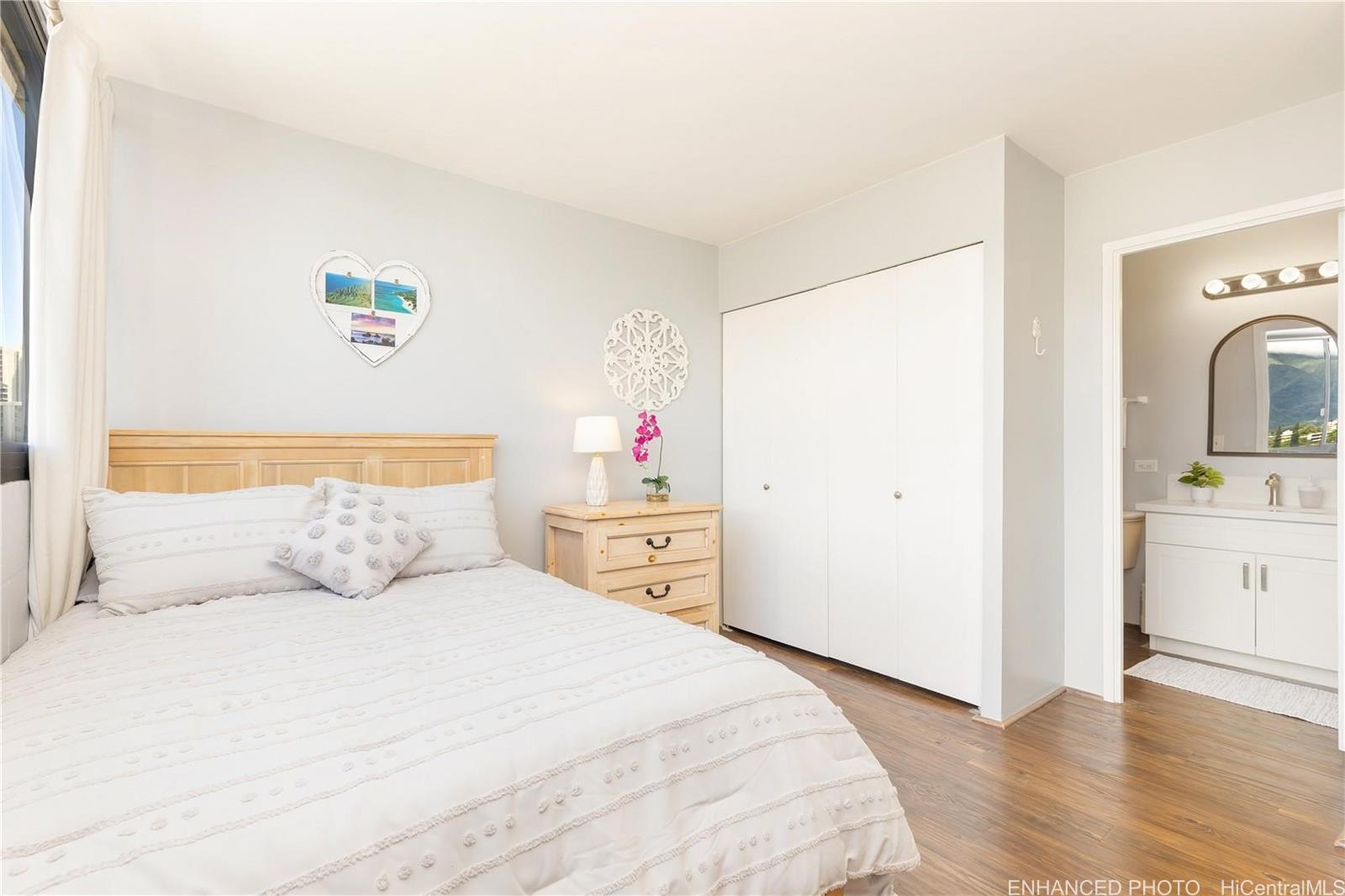 739 Hausten Street, Unit 901 Honolulu, HI 96826 - Photo 13 of 24 a bedroom with a bed and a refrigerator