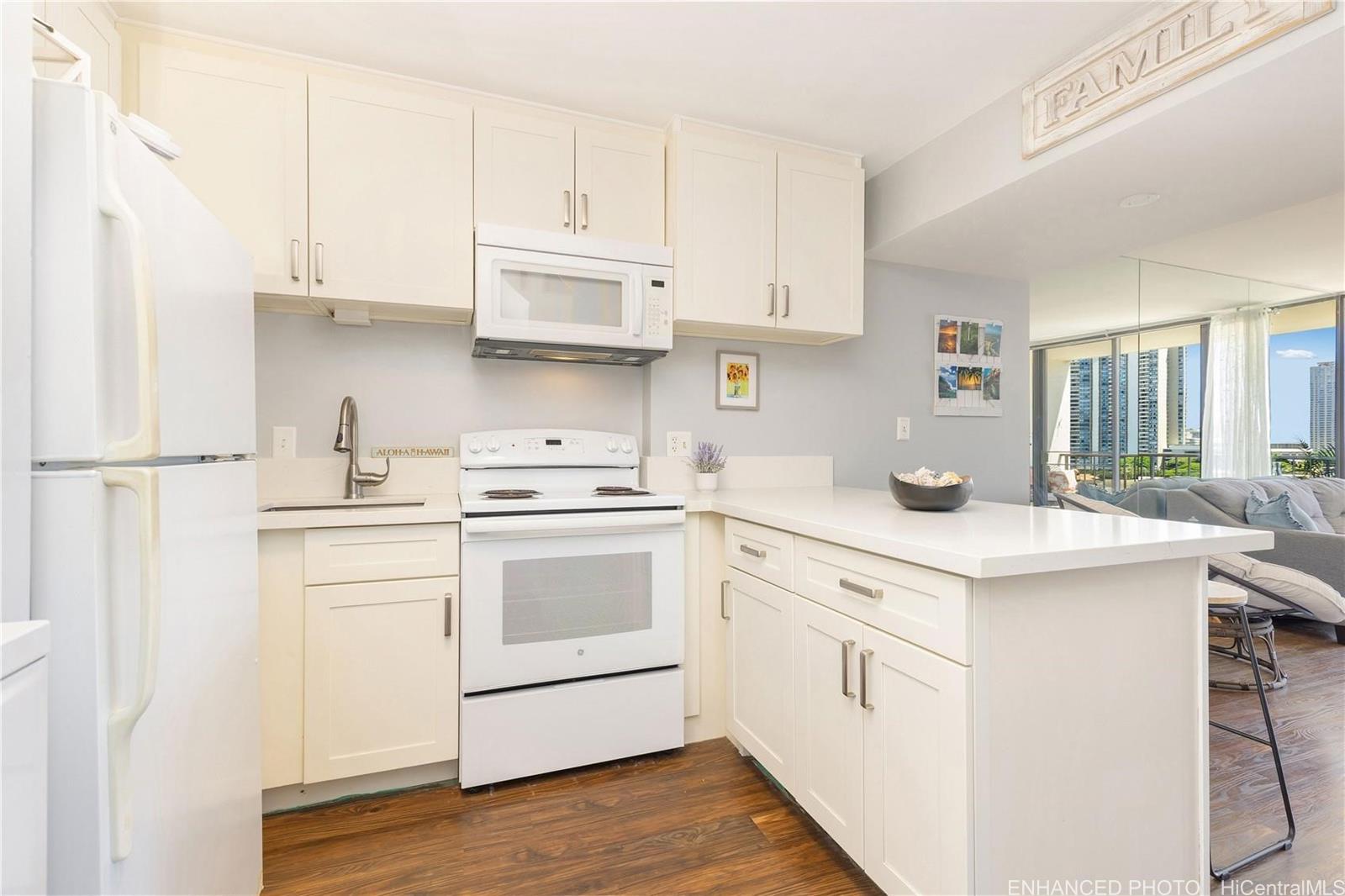 739 Hausten Street, Unit 901 Honolulu, HI 96826 - Photo 8 of 24 a kitchen with white cabinets and white appliances