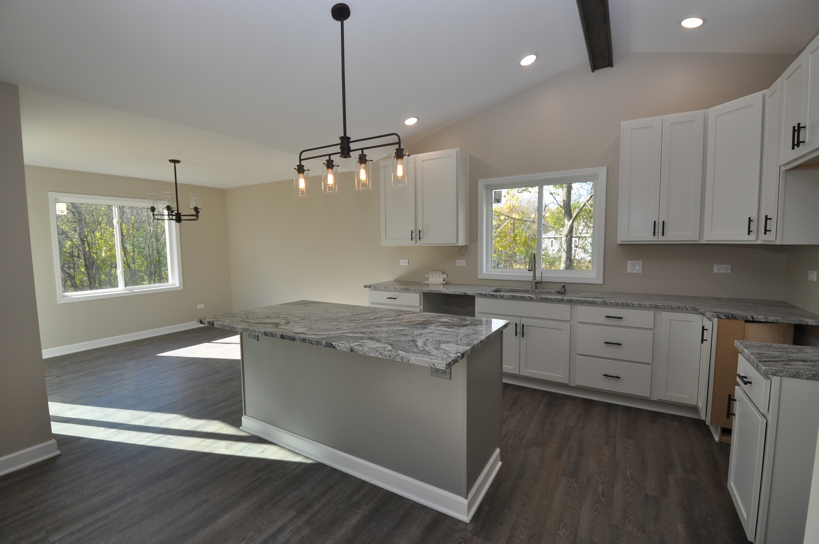 26369 Park Place Antioch, IL 60002 - Photo 13 of 24 a kitchen with granite countertop cabinets a sink dishwasher and a stove with wooden floor