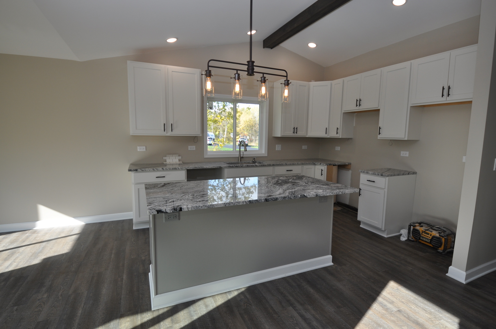 26369 Park Place Antioch, IL 60002 - Photo 14 of 24 a kitchen with kitchen island granite countertop a sink cabinets and wooden floor
