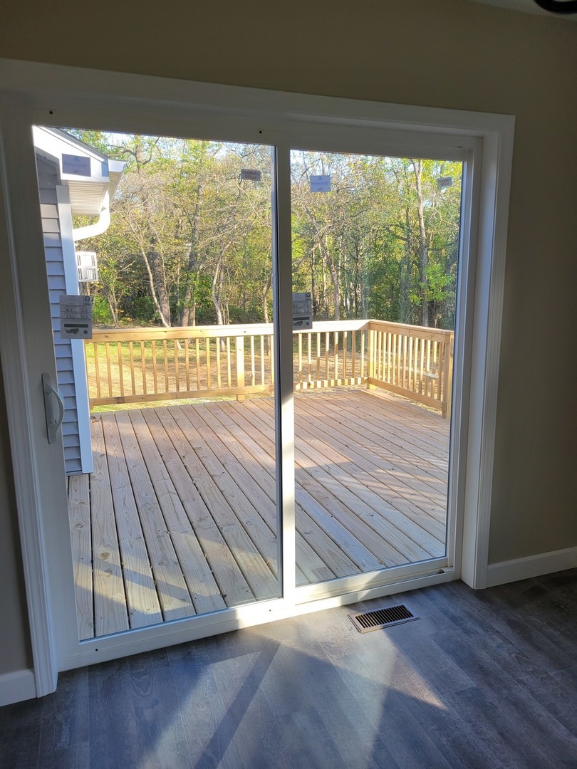 26369 Park Place Antioch, IL 60002 - Photo 17 of 24 a view of an empty room with wooden floor and a window