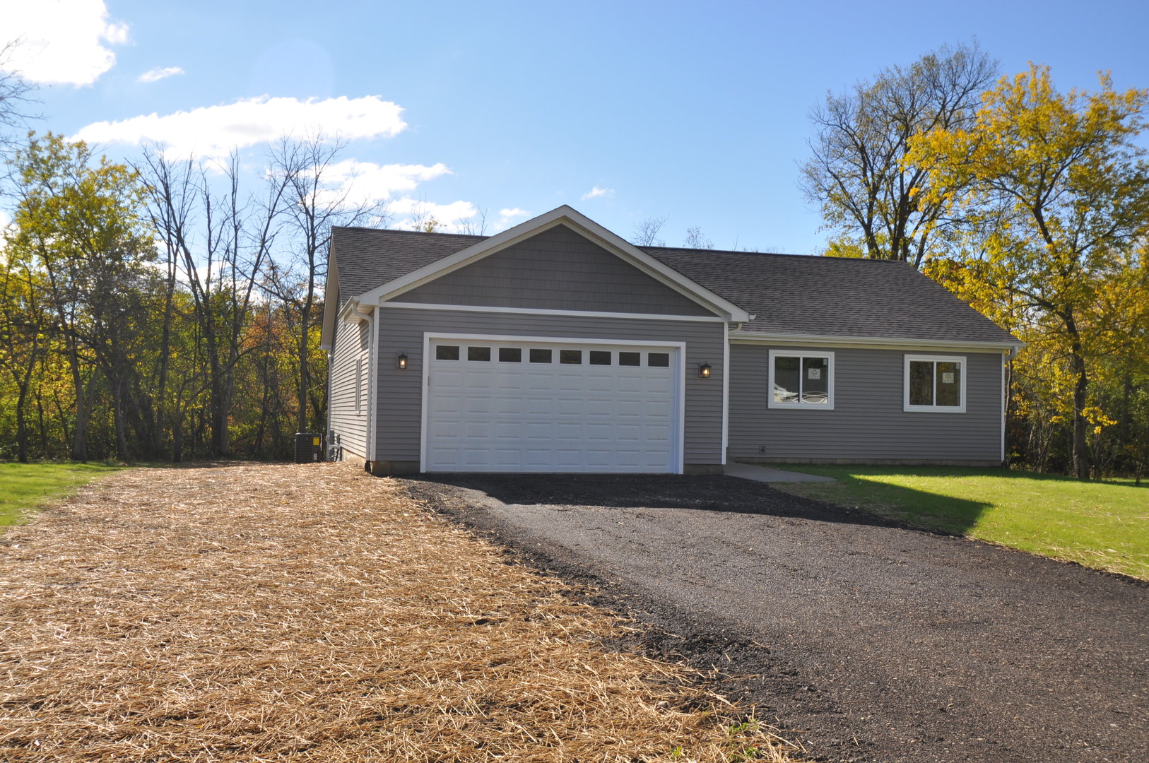 26369 Park Place Antioch, IL 60002 - Photo 2 of 24 a front view of a house with a yard and garage