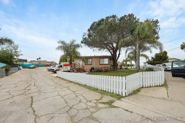 a view of street with wooden fence