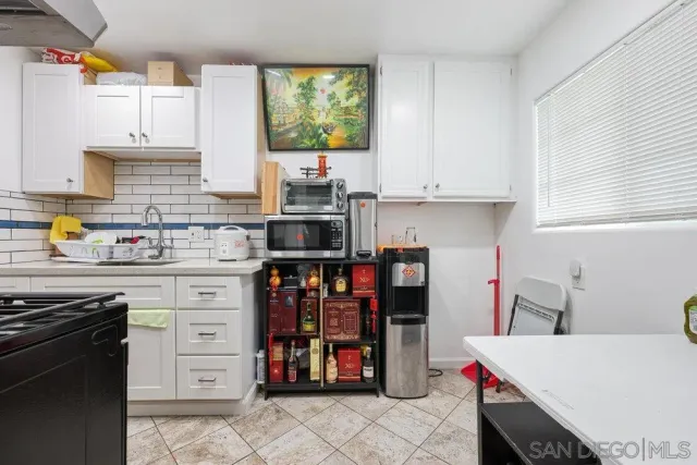 a kitchen with stainless steel appliances a stove and more cabinets