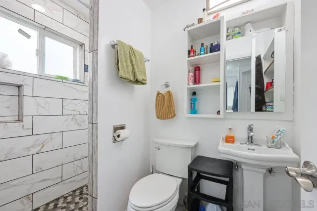 a bathroom with a sink toilet and mirror