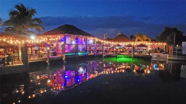 a lake view with a swimming pool and table in a patio
