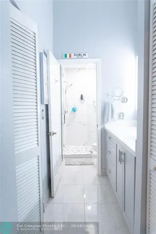 a bathroom with a granite countertop shower a sink and a mirror