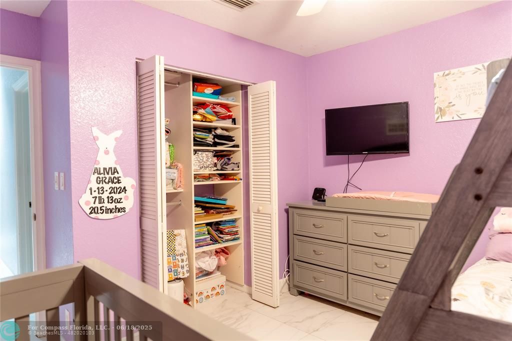 1102 Southwest 158th Avenue Pembroke Pines, FL 33027 - Photo 17 of 27 a bedroom with a bed and a flat screen tv