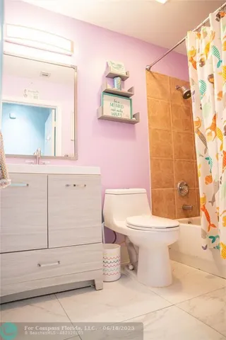 a bathroom with a toilet sink and shower