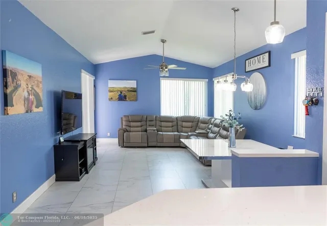 a living room with couches and painting on the wall