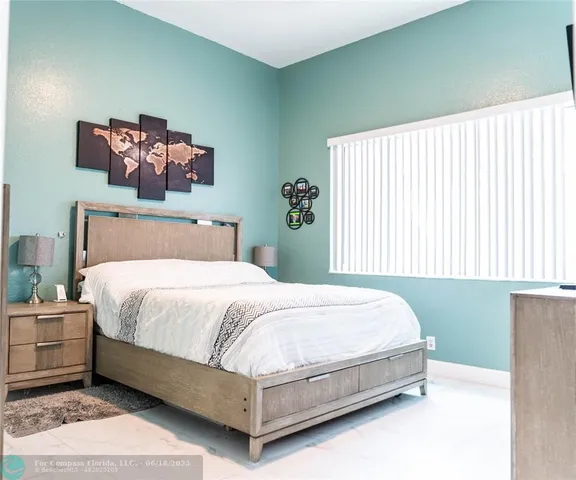 a bed sitting in a bedroom next to a window