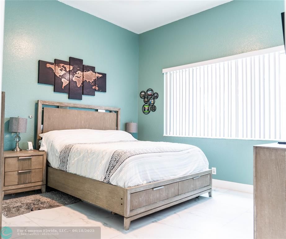 1102 Southwest 158th Avenue Pembroke Pines, FL 33027 - Photo 9 of 27 a bed sitting in a bedroom next to a window