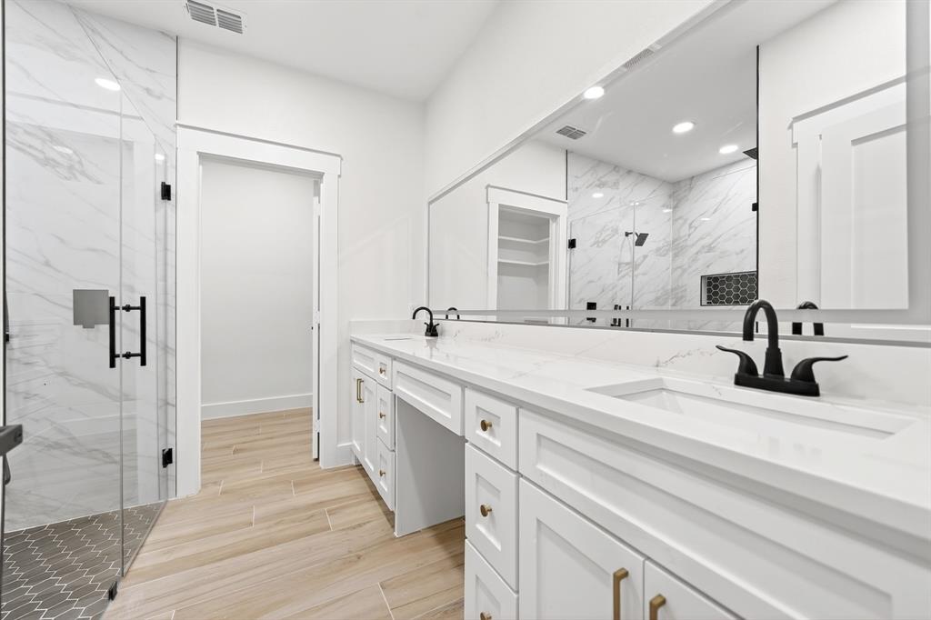 120 Springwood Road Enchanted Oaks, TX 75156 - Photo 22 of 37 Bathroom featuring a double vanity with white cabinetry, gold-toned hardware, and white countertops