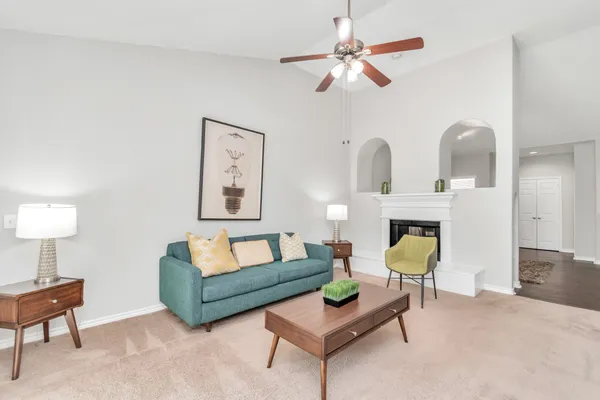 a living room with furniture and a chandelier