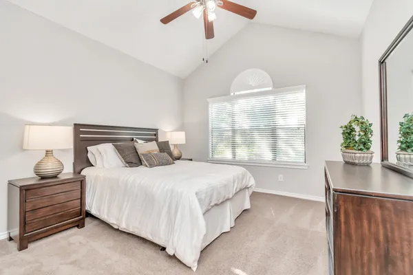 a bedroom with a bed and window