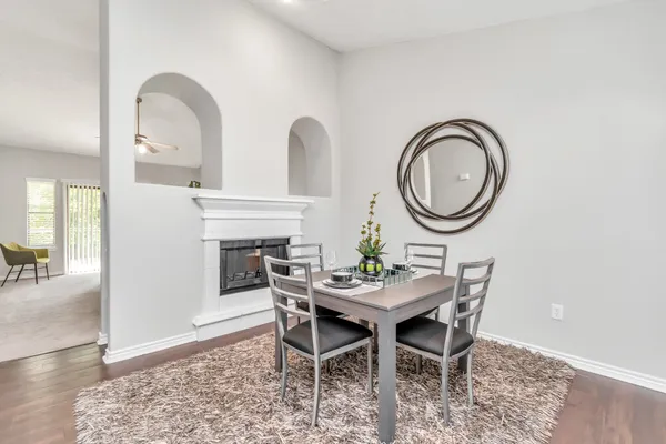 a dining room with furniture and a mirror