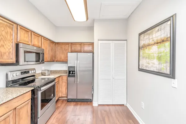 a kitchen with stainless steel appliances a refrigerator sink and microwave