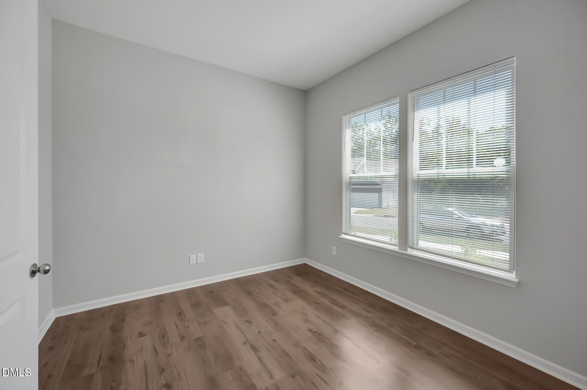 5406 Ripplebrook Drive Durham, NC 27712 - Photo 5 of 37 a view of an empty room with wooden floor and a window