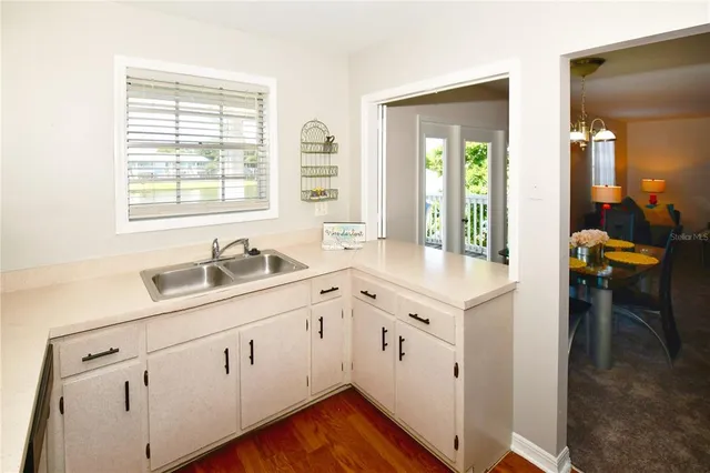 a kitchen with cabinets appliances and a sink