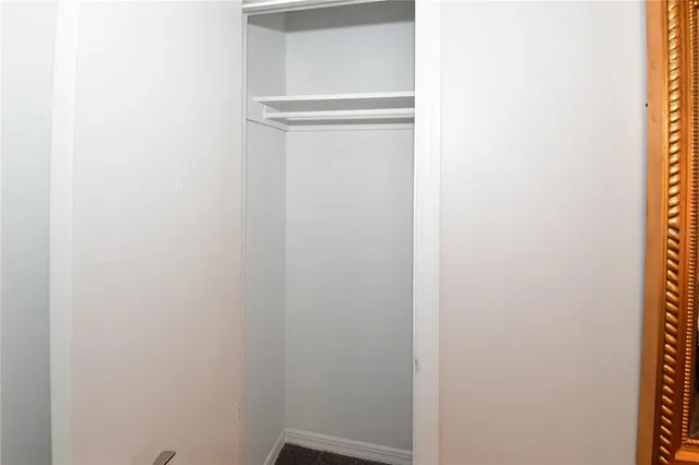 a bedroom with a bed and a lamp on table