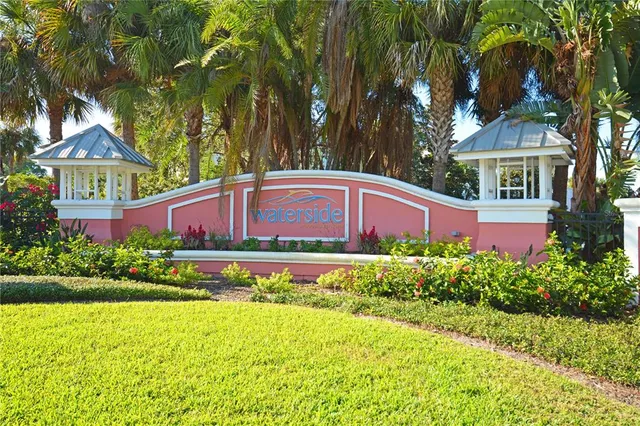 a front view of a house with a yard and large trees