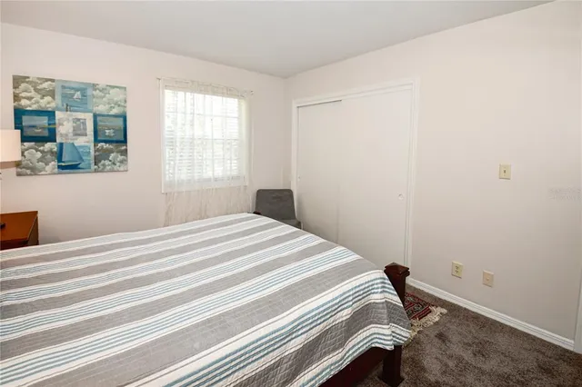 a bedroom with a bed and a lamp