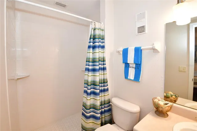 a bathroom with a sink vanity mirror and tub