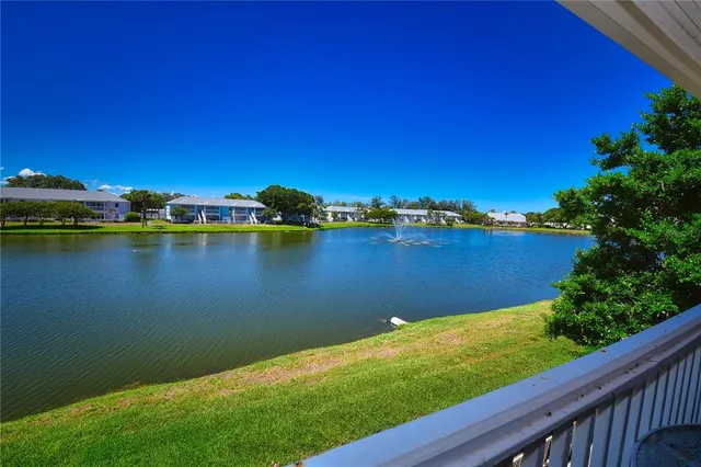 a view of a lake with houses in the back