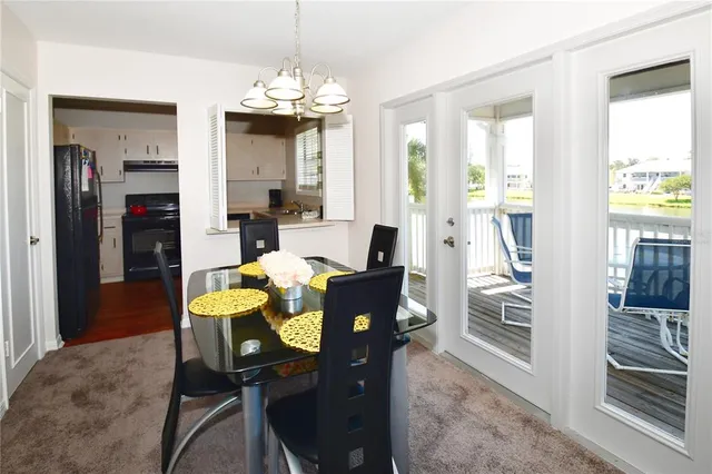 a view of a dining room with furniture and a chandelier