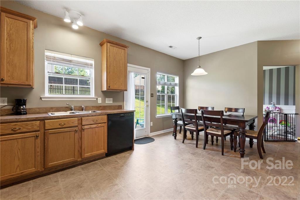 420 Wrayhill Drive Charlotte, NC 28262 - Photo 11 of 22 a large kitchen with kitchen island a sink table and chairs