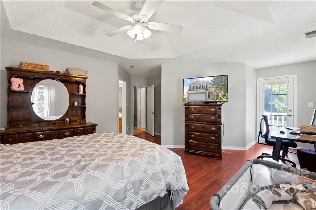 420 Wrayhill Drive Charlotte, NC 28262 - Photo 13 of 22 a bedroom with a bed a mirror on dresser and a window