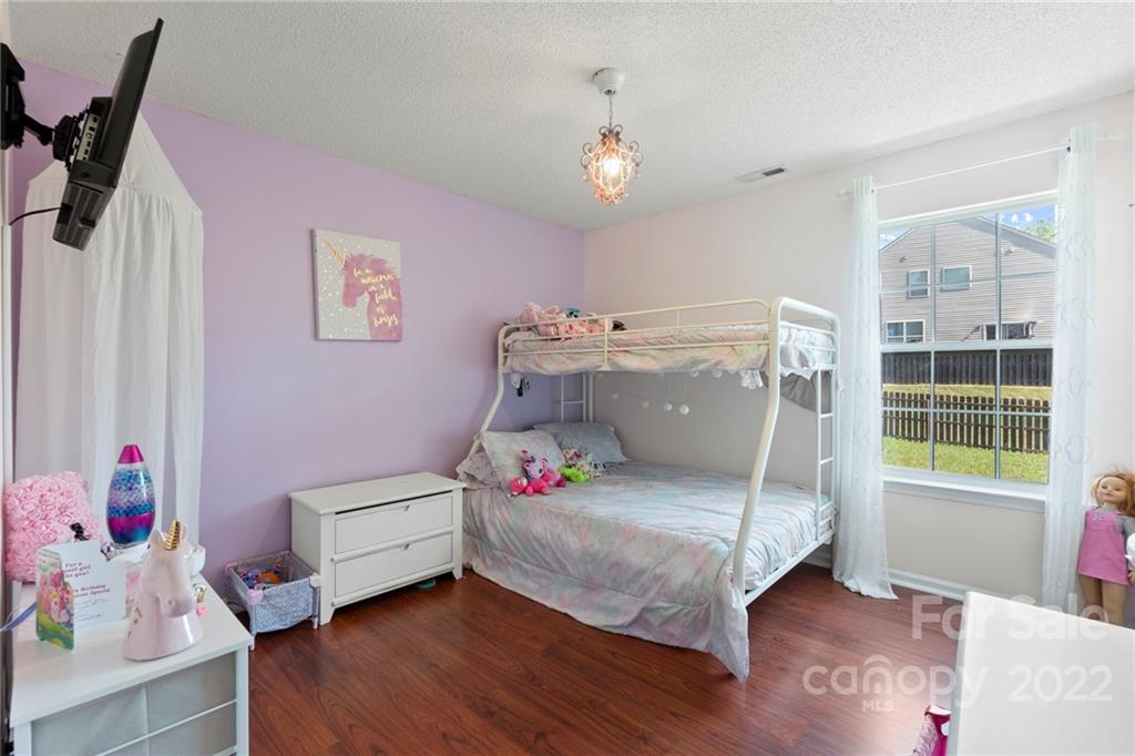 420 Wrayhill Drive Charlotte, NC 28262 - Photo 18 of 22 a bedroom with a bed and wooden floor