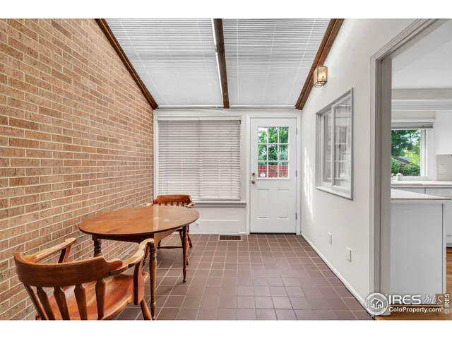 a view of a room with furniture and wooden floor