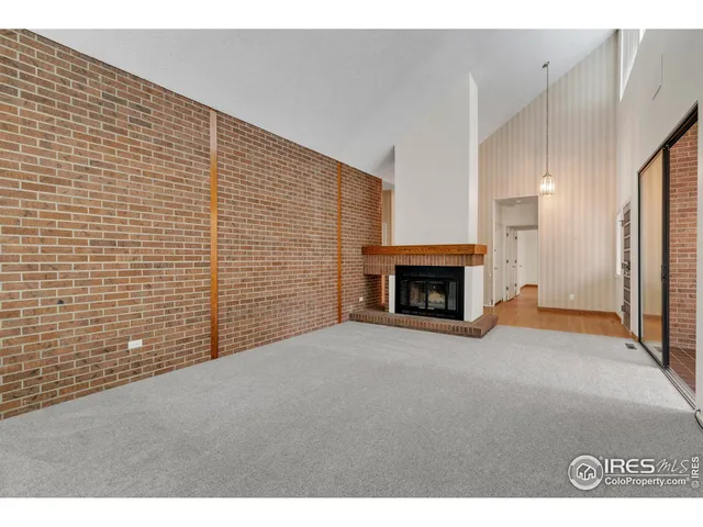 a view of an empty room with a fireplace