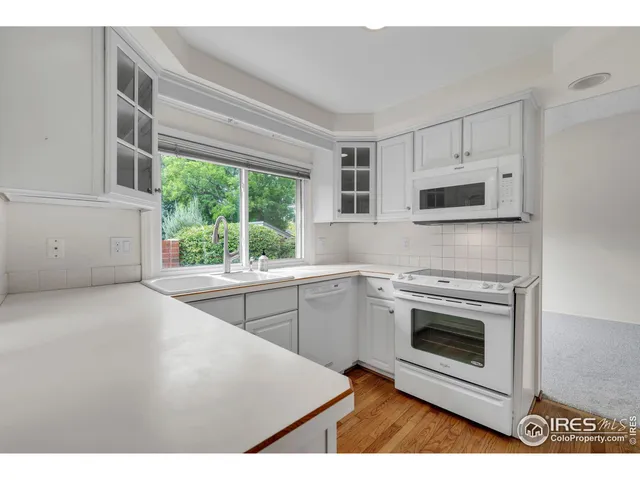 a kitchen with a stove a sink and a microwave