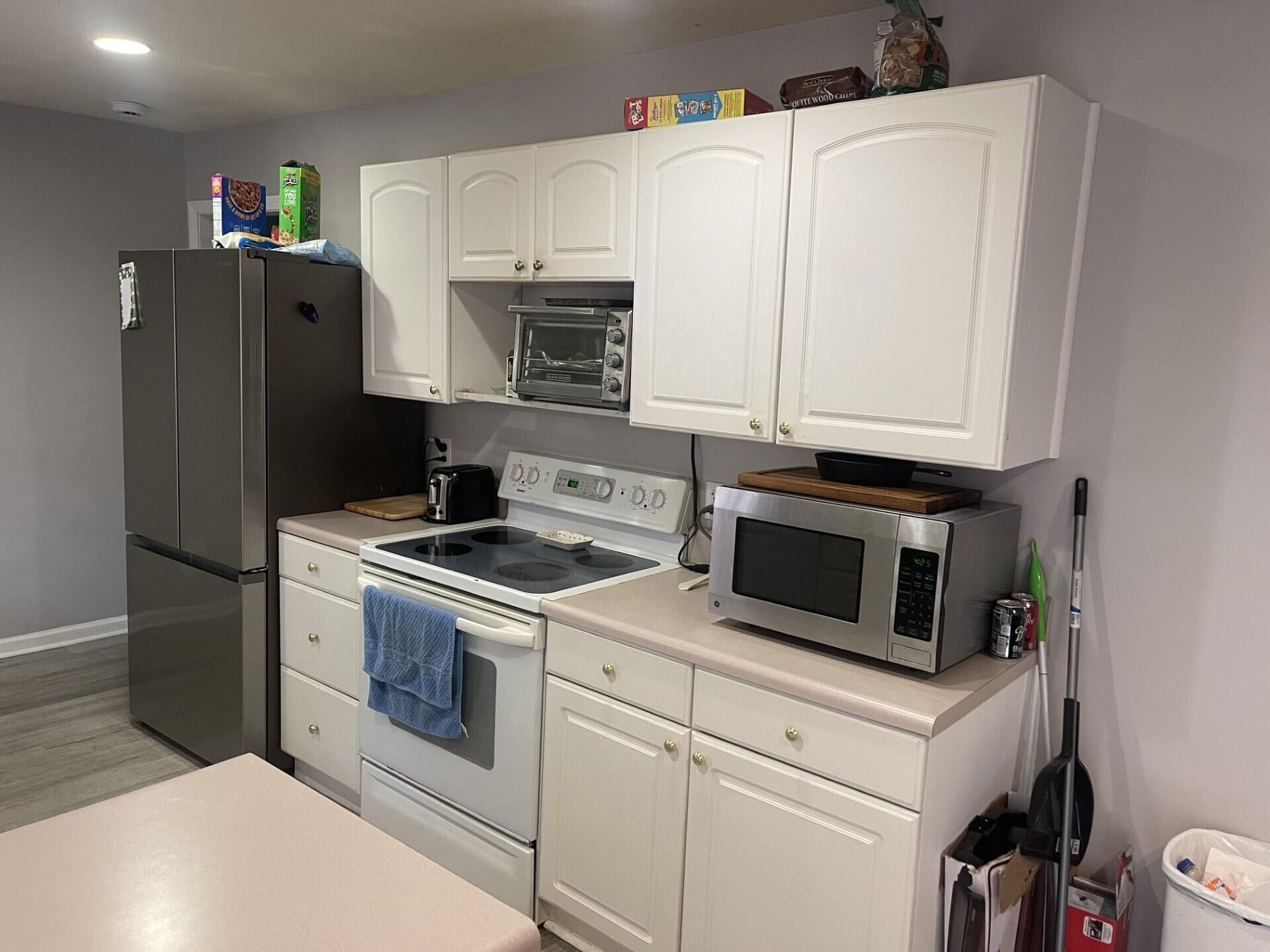 1239 Dossett Street Athens, TN 37303 - Photo 5 of 11 a kitchen with stainless steel appliances white cabinets and a refrigerator