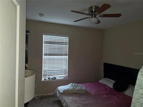 a bedroom with a bed and a window