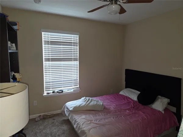 a bedroom with a bed and window