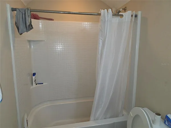 a bathroom with a shower and a tub