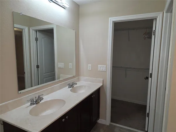 a bathroom with a sink double vanity and a mirror